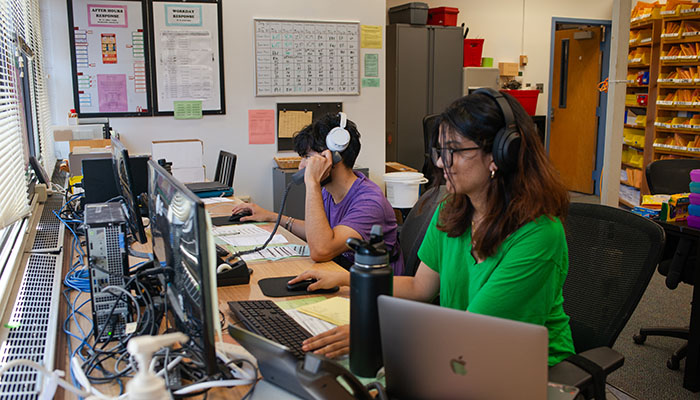 two student employees working at a desk the Service Center