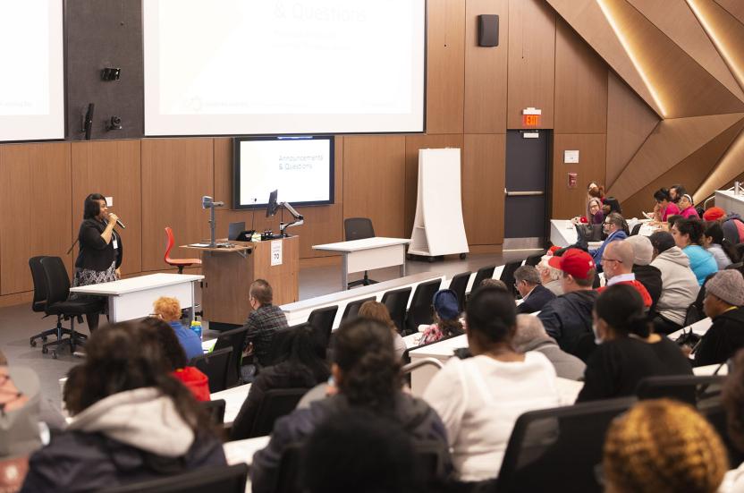 angela jackson presenting at learning day in front of auditorium