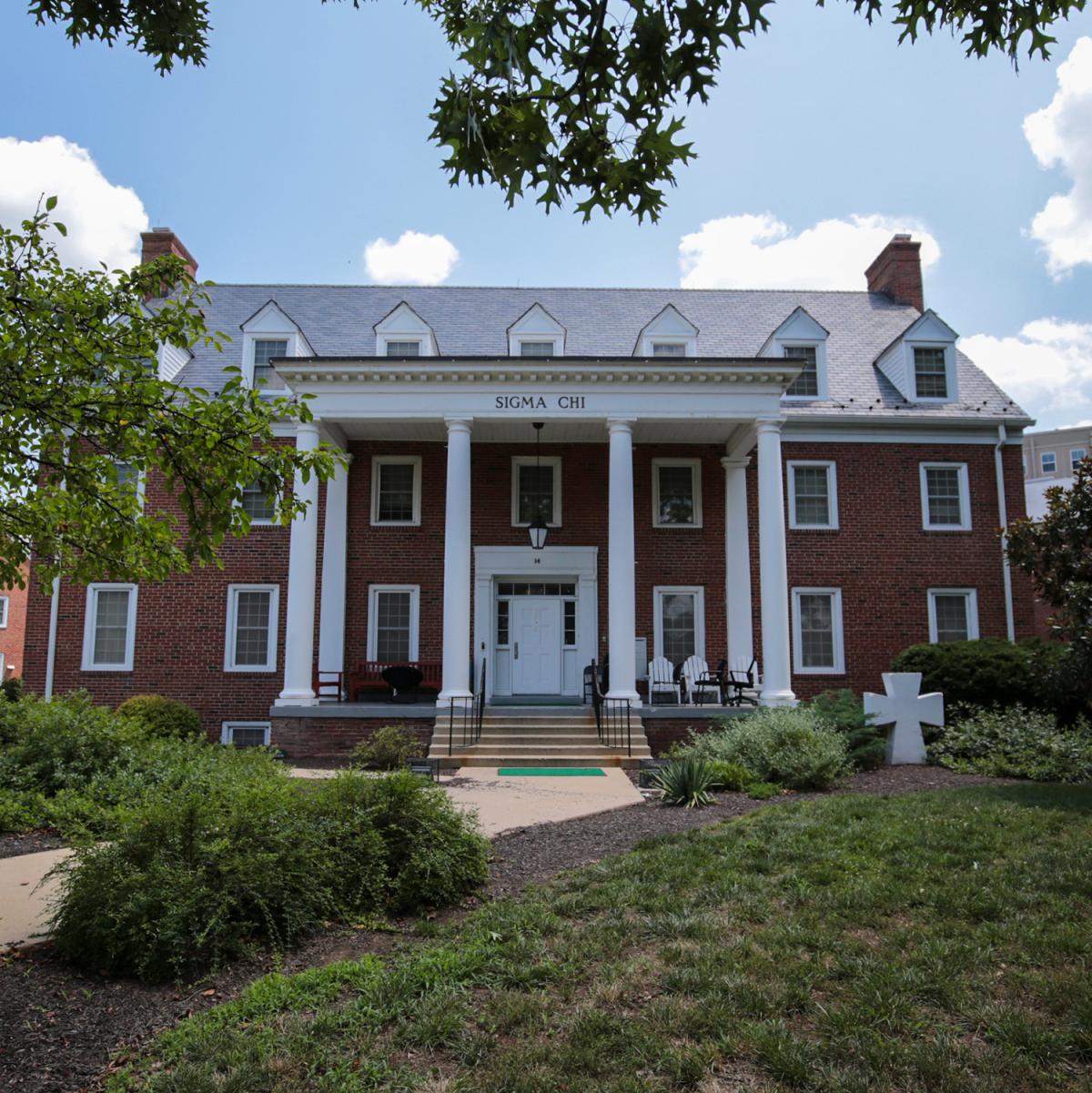 Brick house at 14 Fraternity Row with white columns and surrounding greenery