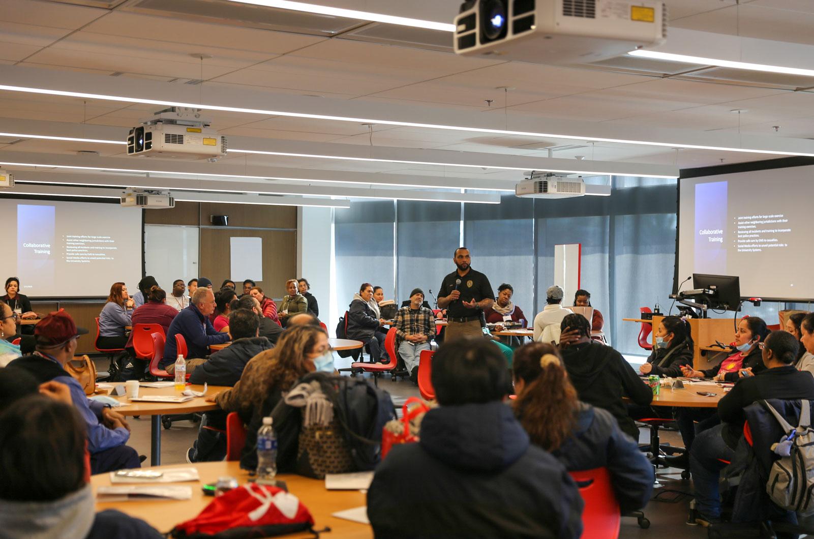 UMPD Captain Fields presenting on active shooter training to a large classroom