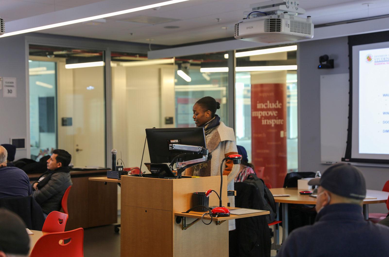 Aliraba Nsereko presenting in a classroom