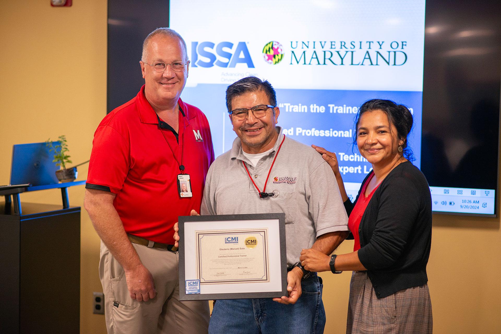 Manuel Soto receiving certification from Vassie Hollamon and Isabel Marroquin