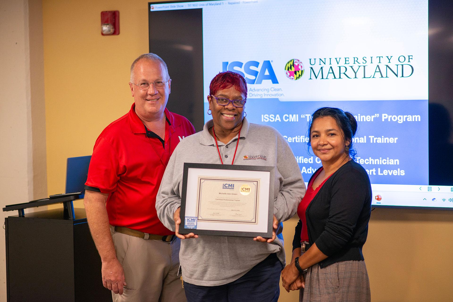 Michelle Isler-Green  receiving certification from Vassie Hollamon and Isabel Marroquin