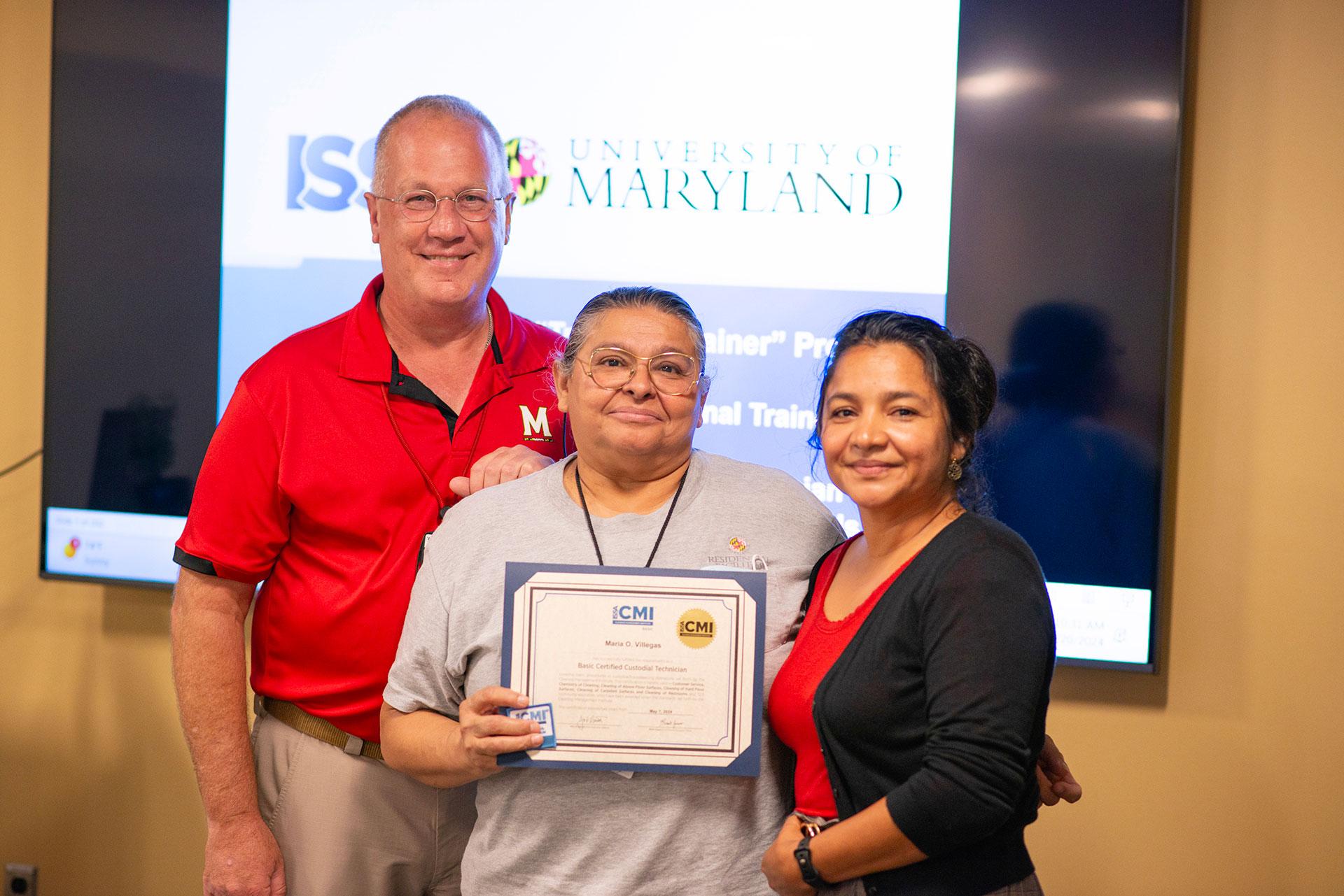 Maria Villegas  receiving certification from Vassie Hollamon and Isabel Marroquin