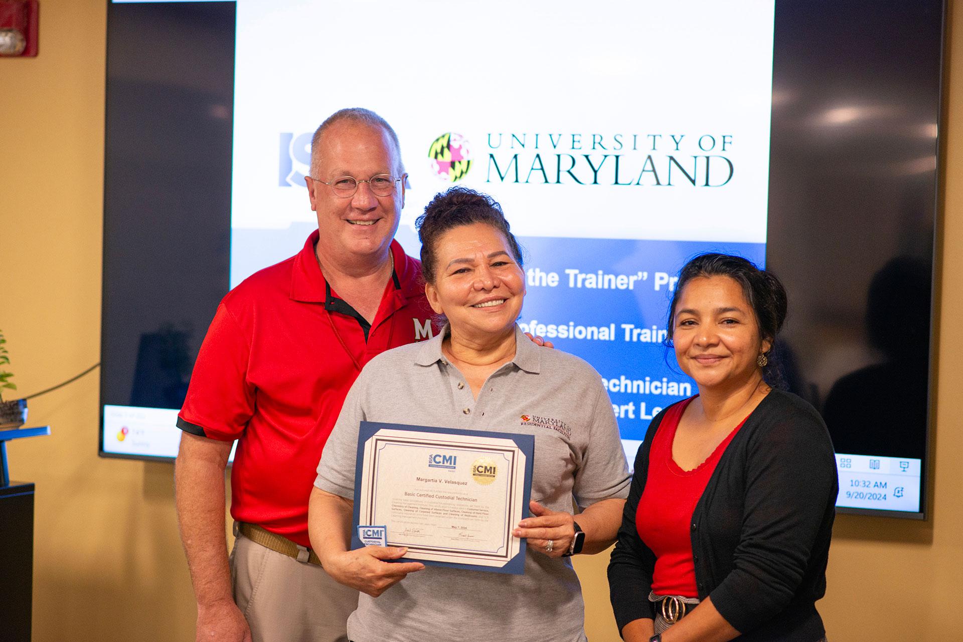 Margarita Velasquez  receiving certification from Vassie Hollamon and Isabel Marroquin