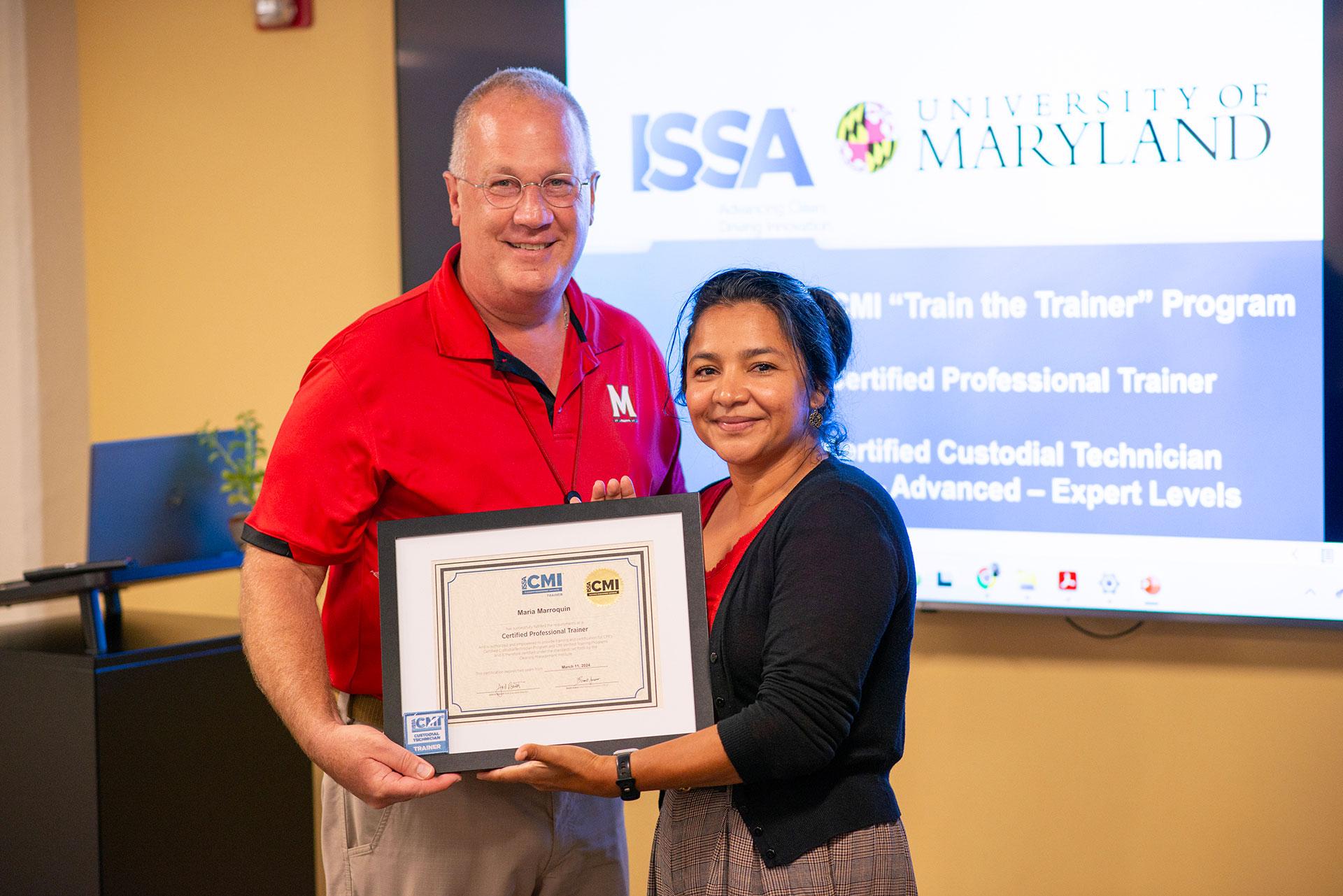 Isabel Marroquin  receiving certification from Vassie Hollamon