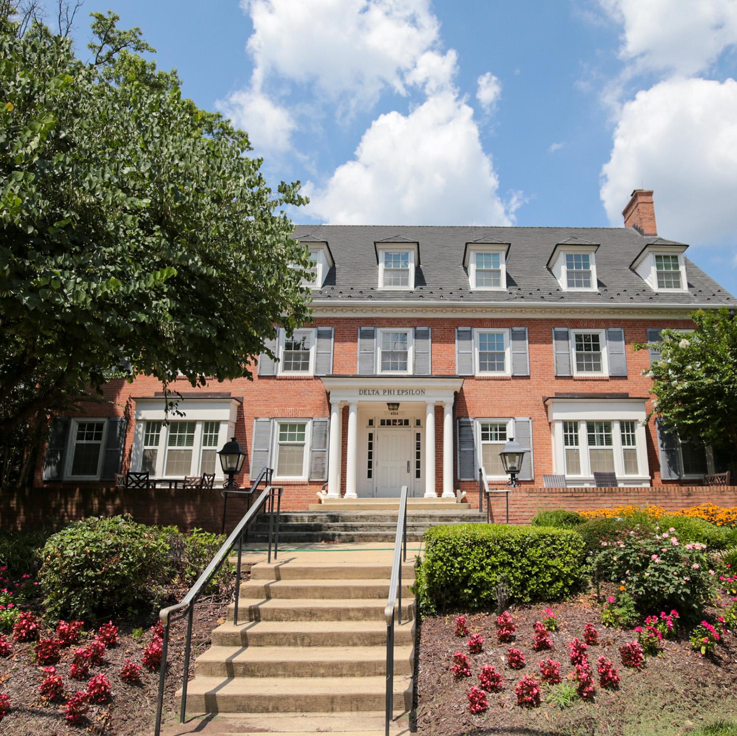 Brick house at 4514 Knox Rd with window shutters, white columns, and a front entrance framed by colorful flower beds