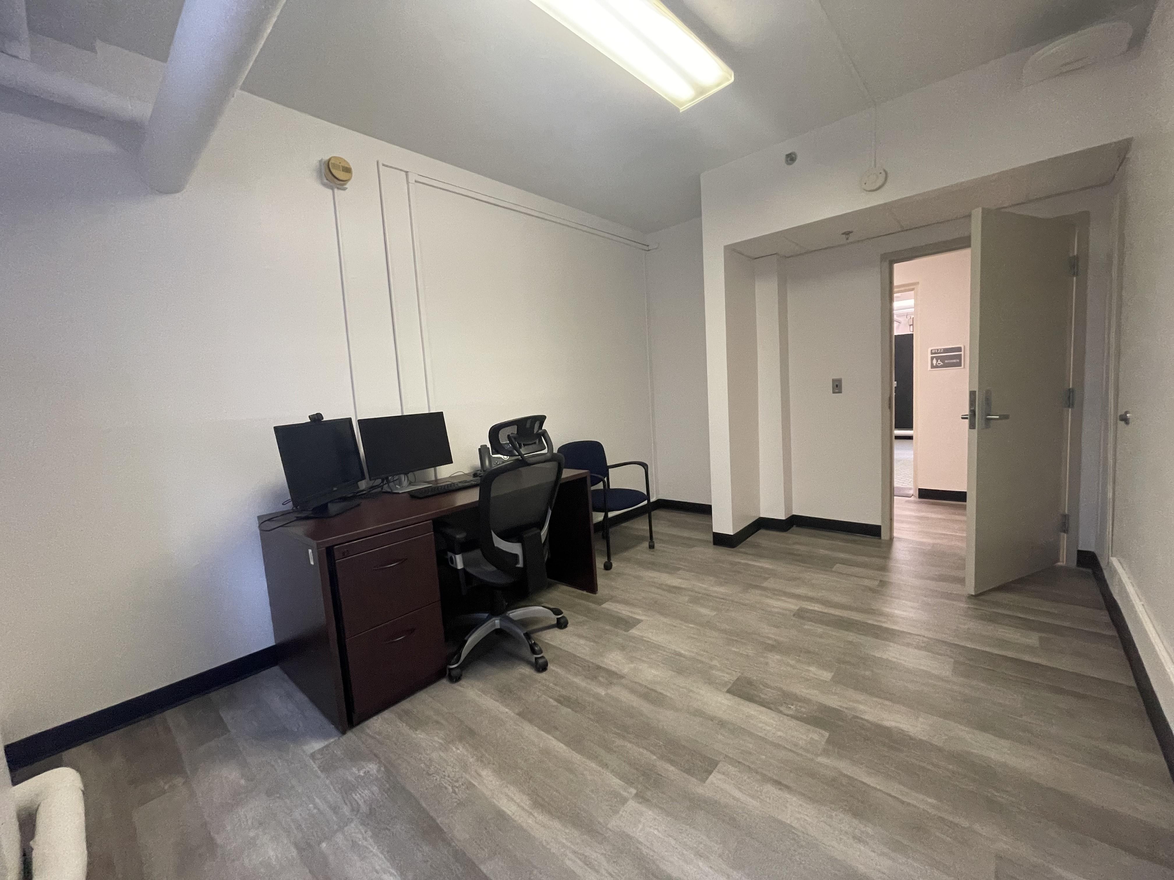 Private office with desk, computer setup and accessible doorway in the renovated ADS space.