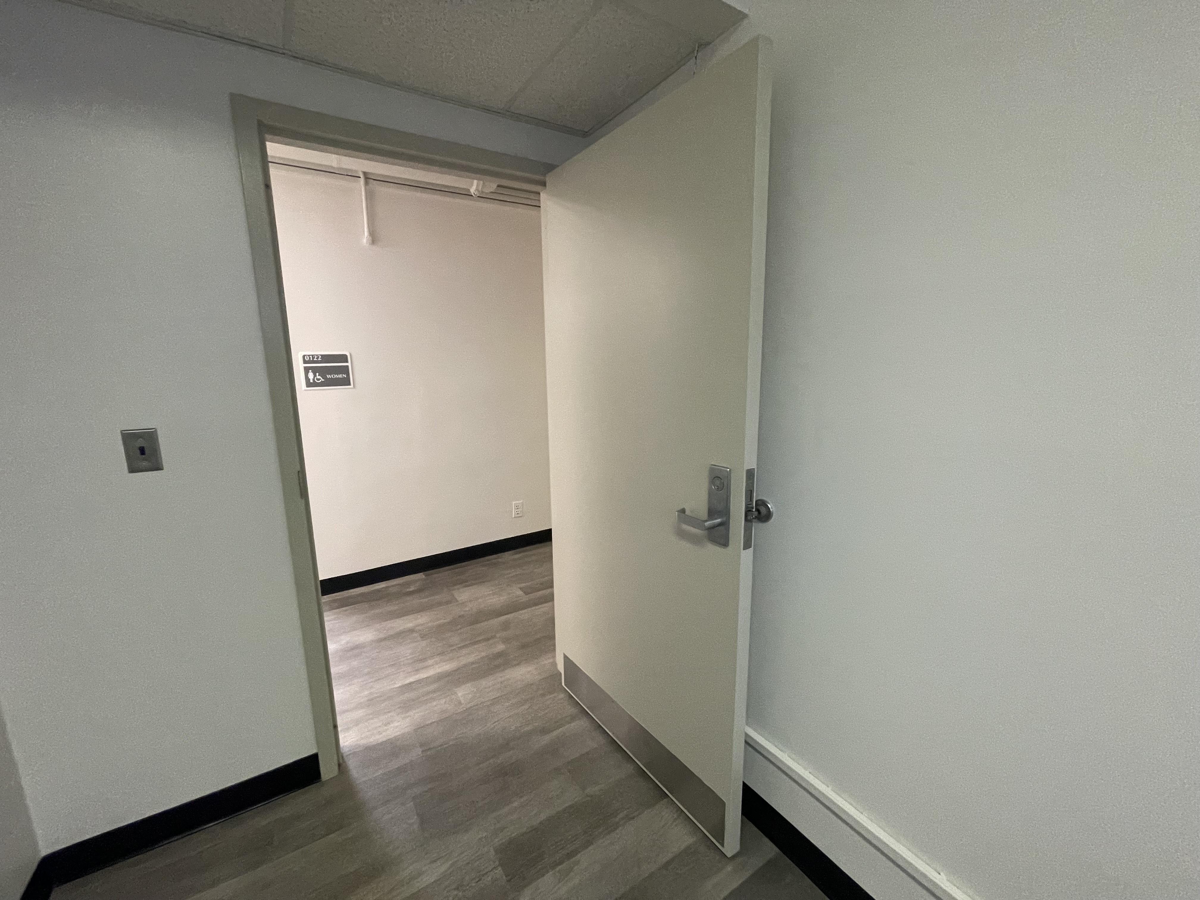 Accessible doorway leading into an office space, featuring widened entry for improved mobility access.