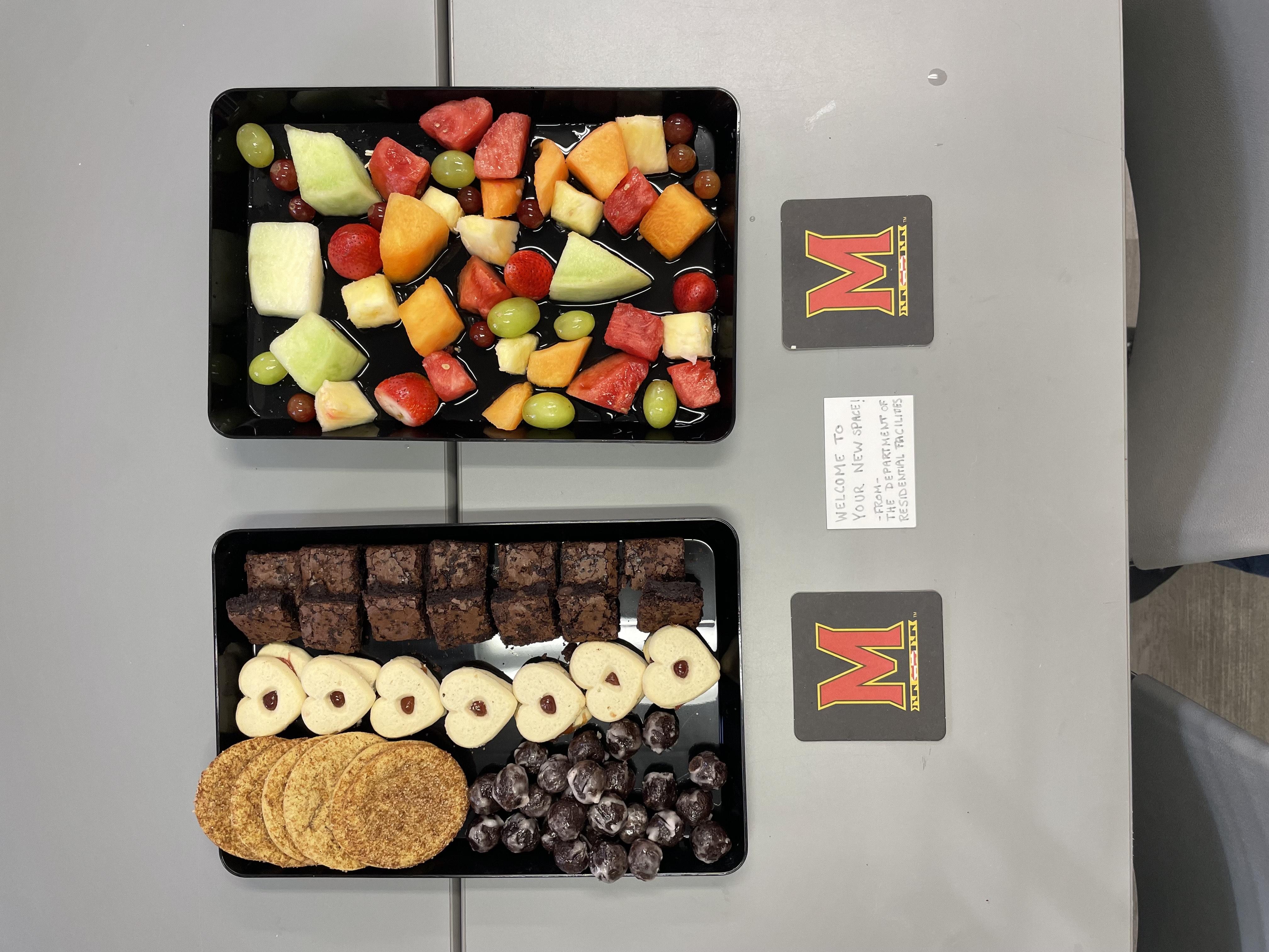 Welcome display with fruit, cookies and brownies on a table, celebrating the ADS team’s move into Caroline Hall.